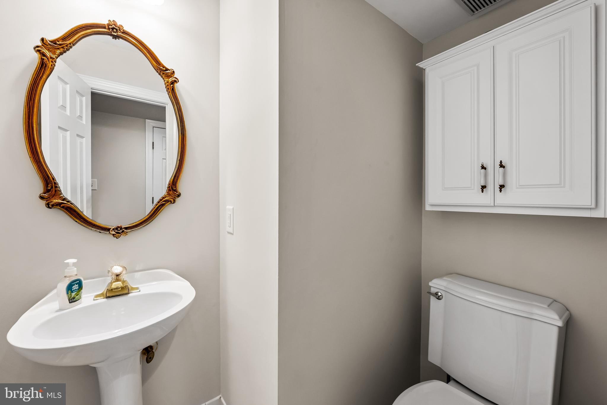 8315 Saddle Ridge Terrace Ellicott City, MD 21043 - Photo 9 of 62 a bathroom with a sink a mirror and a toilet