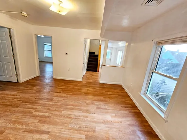 a view of an entryway with wooden floor
