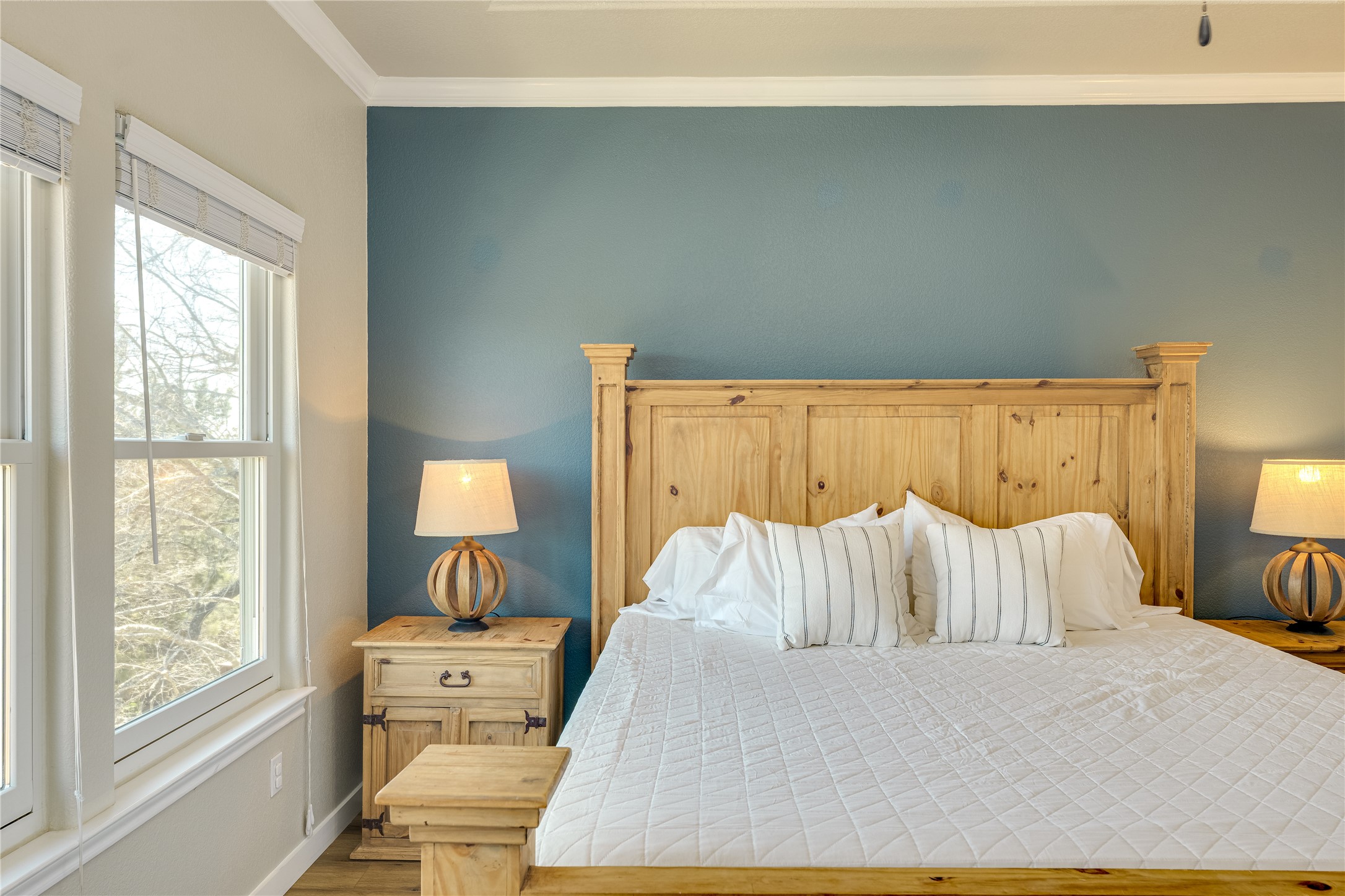 330 Southwind Road Point Venture, TX 78645 - Photo 17 of 37 A calming accent wall paired with the warm flooring, and natural light, makes it easy to wind down.
