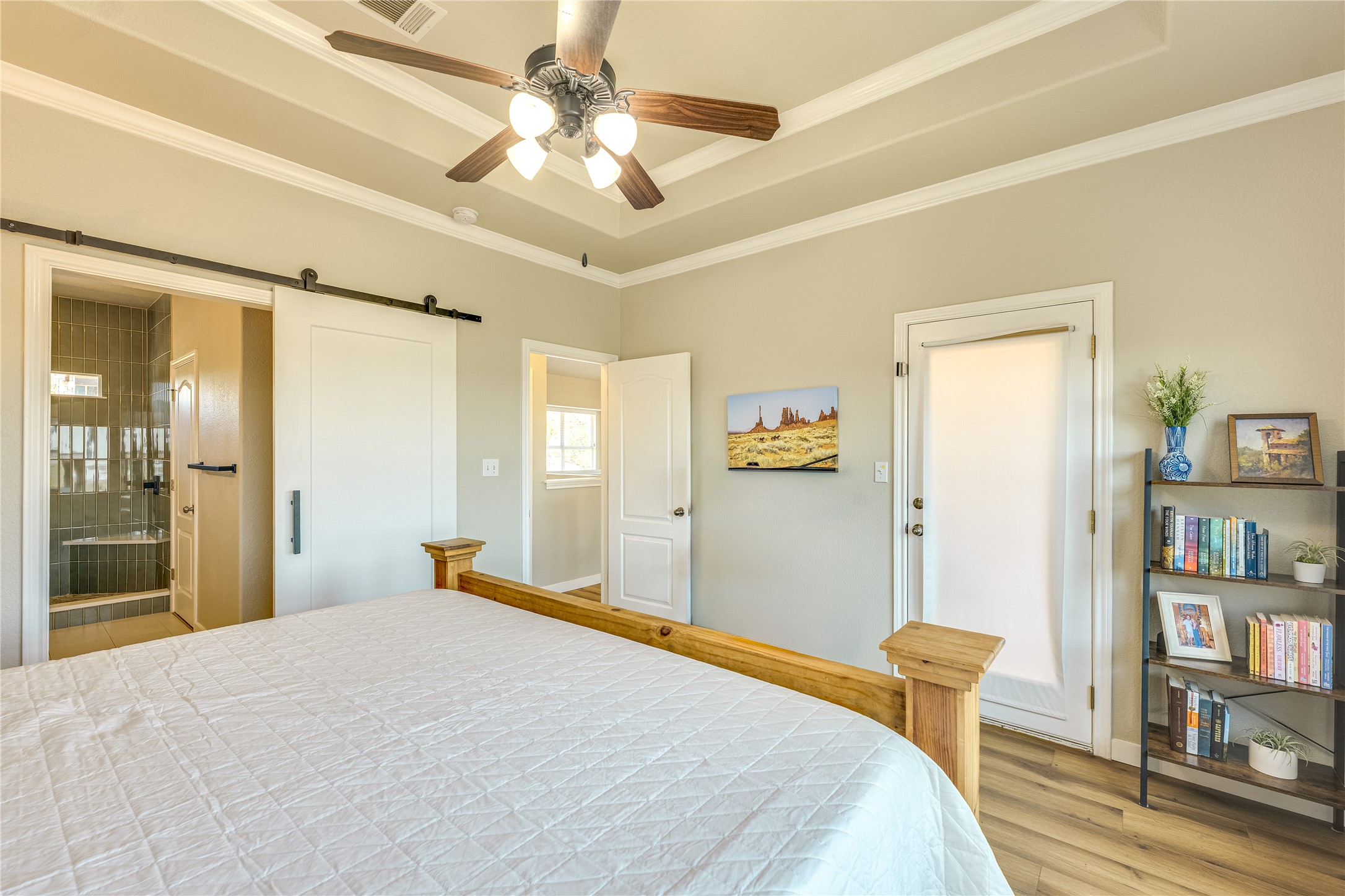 330 Southwind Road Point Venture, TX 78645 - Photo 18 of 37 The ensuite is closed off by a sliding barn door.