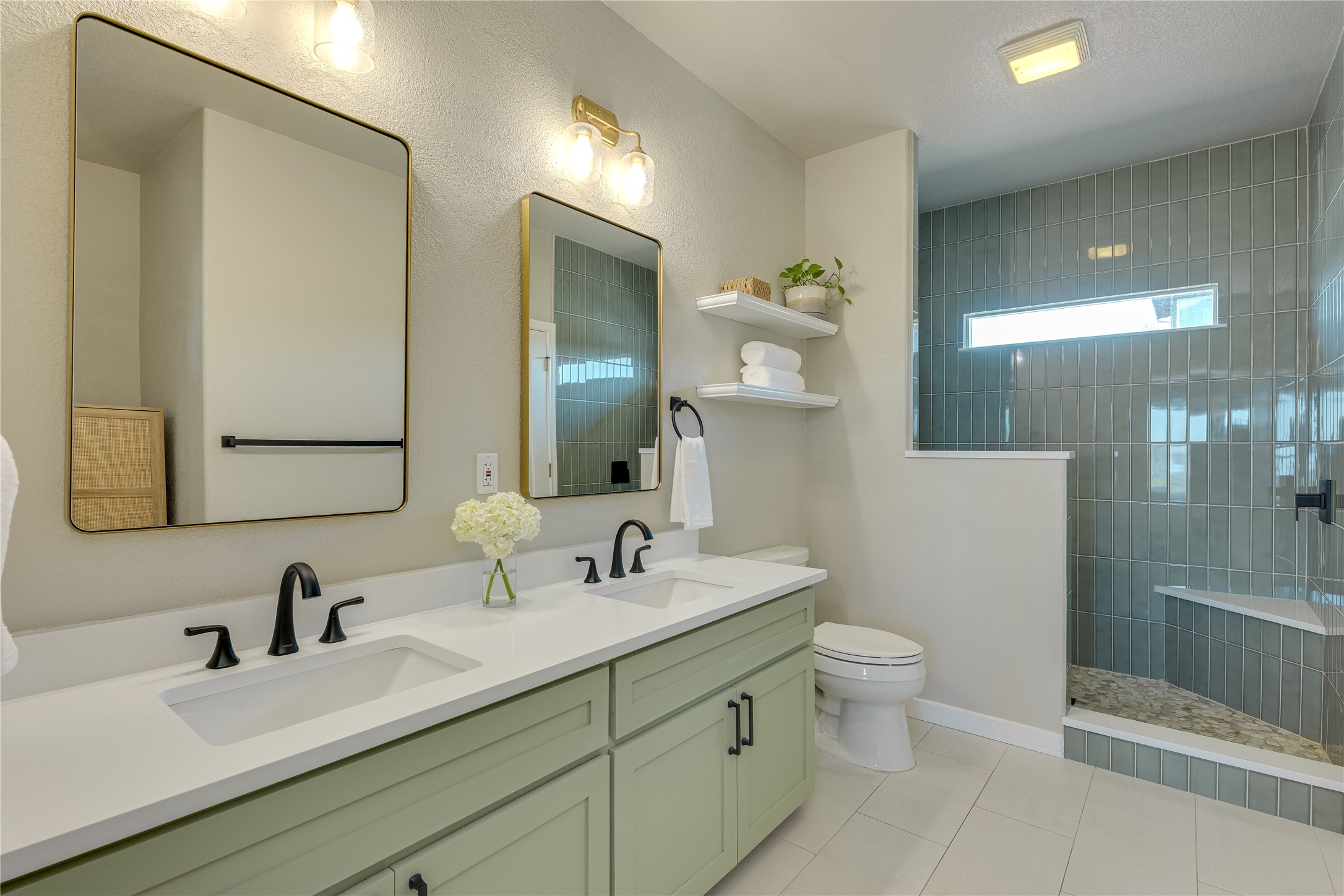 330 Southwind Road Point Venture, TX 78645 - Photo 19 of 37 A primary ensuite made for easy mornings, double vanity space and a walk-in shower that feels like a mini spa.