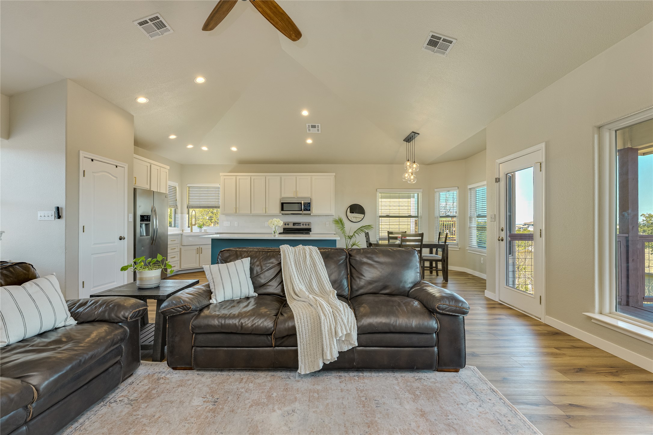 330 Southwind Road Point Venture, TX 78645 - Photo 9 of 37 One open space, three favorite spots: kitchen, dining, living, all connected and all chasing the view.