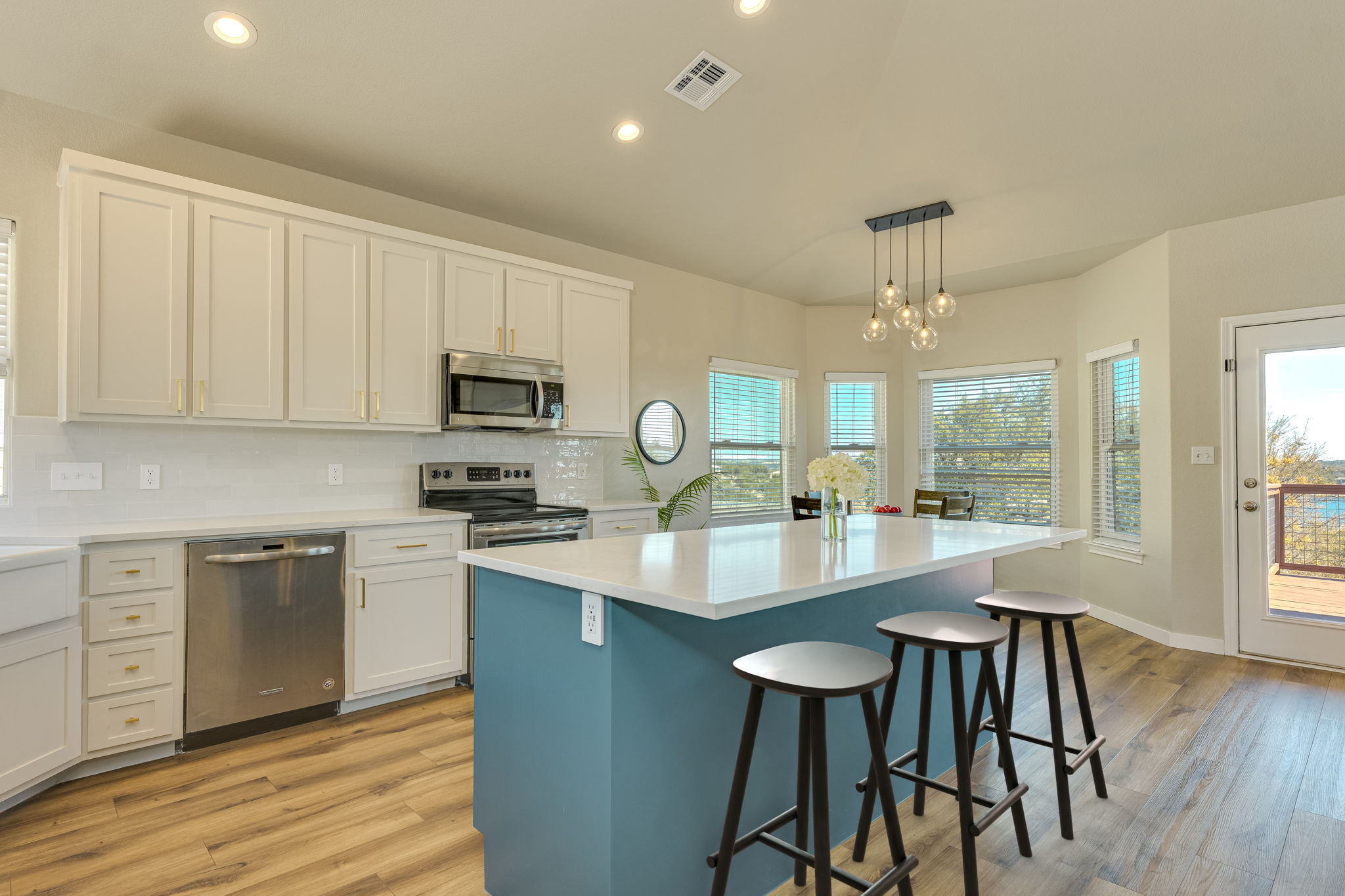 330 Southwind Road Point Venture, TX 78645 - Photo 10 of 37 The large quartz islane is equal parts prep space, snack bar, and the place everyone ends up gathering.