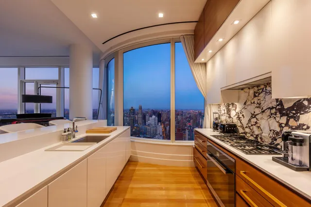 a view of a glass door and porch with a floor to ceiling window