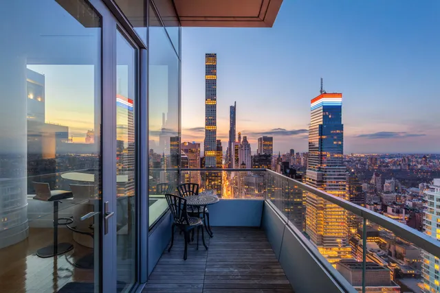 a large kitchen with stainless steel appliances a sink and cabinets