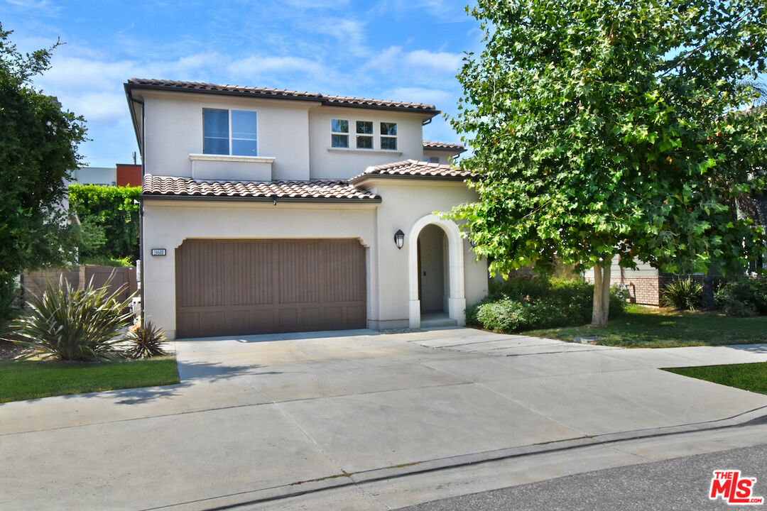 14608 McCormick Street Sherman Oaks, CA 91411 - Photo 1 of 29 a front view of a house with a garden and garage