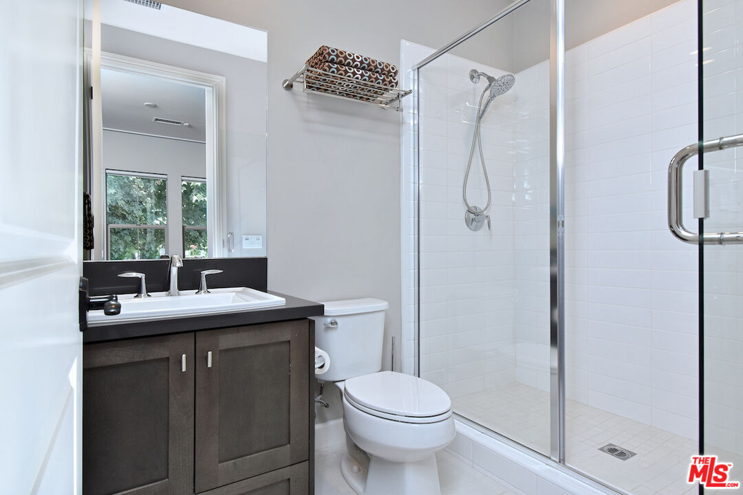 14608 McCormick Street Sherman Oaks, CA 91411 - Photo 12 of 29 a bathroom with a granite countertop sink toilet and shower