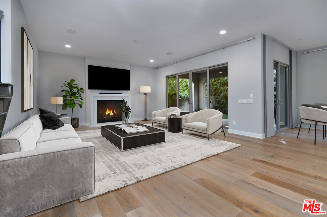 14608 McCormick Street Sherman Oaks, CA 91411 - Photo 5 of 29 a living room with furniture flat screen tv and a fireplace