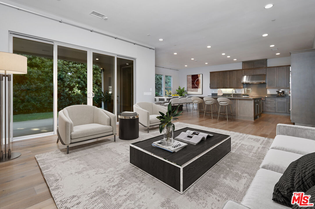 14608 McCormick Street Sherman Oaks, CA 91411 - Photo 6 of 29 a living room with furniture a table and a large window