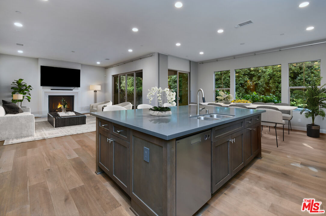 14608 McCormick Street Sherman Oaks, CA 91411 - Photo 7 of 29 a kitchen with kitchen island granite countertop a sink and a stove top oven