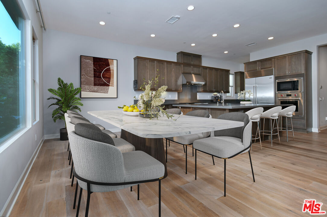14608 McCormick Street Sherman Oaks, CA 91411 - Photo 9 of 29 a kitchen with a table chairs stove and kitchen view