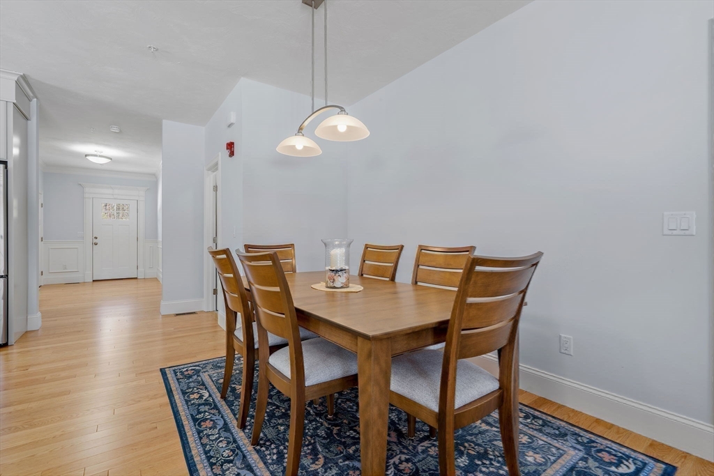 6 Chickadee Way, Unit 23 Upton, MA 01568 - Photo 12 of 41 a view of a dining room with furniture and wooden floor