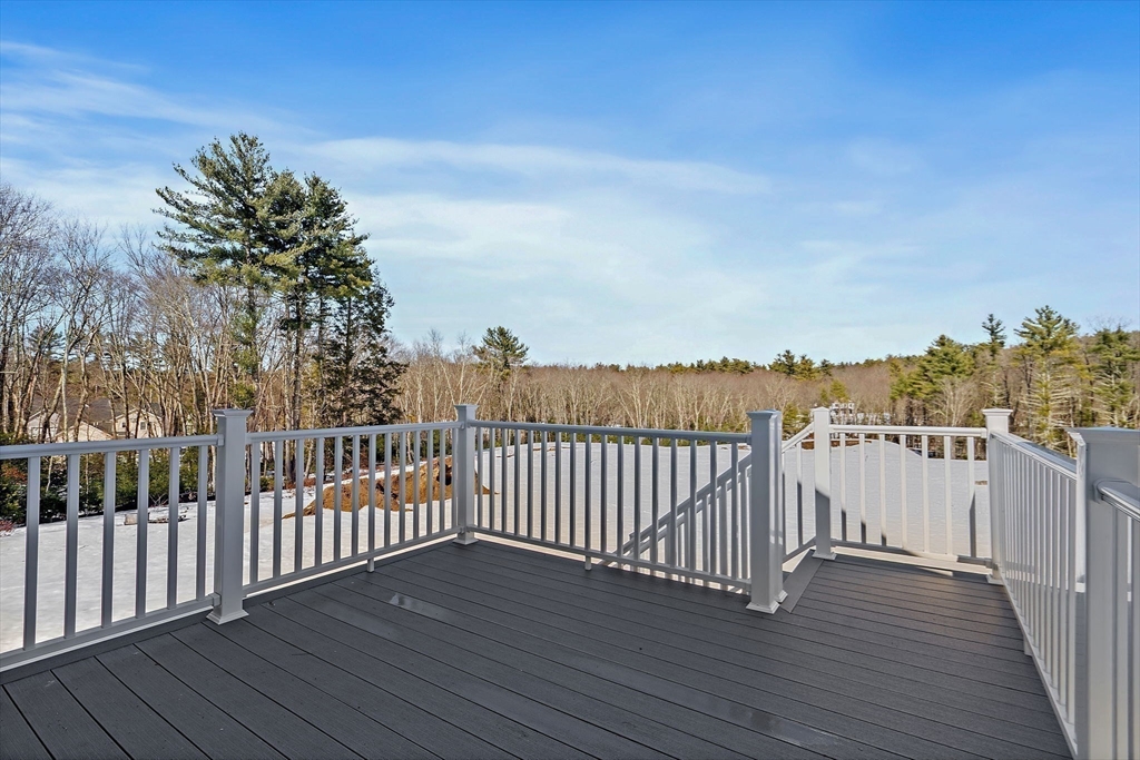 6 Chickadee Way, Unit 23 Upton, MA 01568 - Photo 2 of 40 a view of a balcony with wooden floor and fence