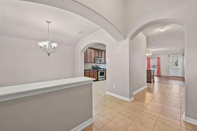 a large kitchen with stainless steel appliances granite countertop a large stove a refrigerator and a sink