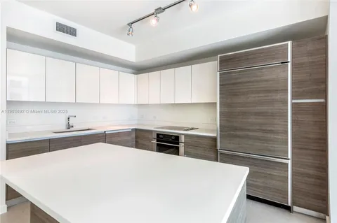 a kitchen with a cabinets and white appliances