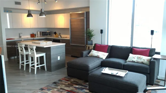 a living room with furniture and a dining table