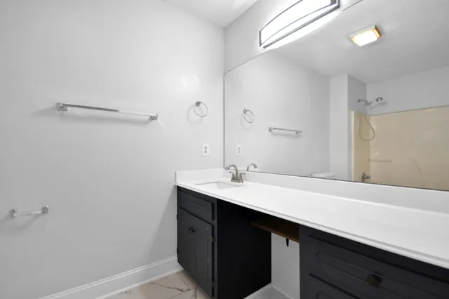 a bathroom with a sink a mirror and a toilet