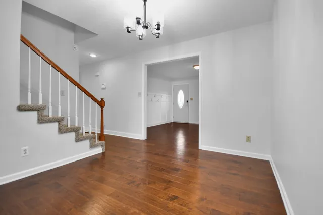 a view of an entryway with wooden floor and staircase