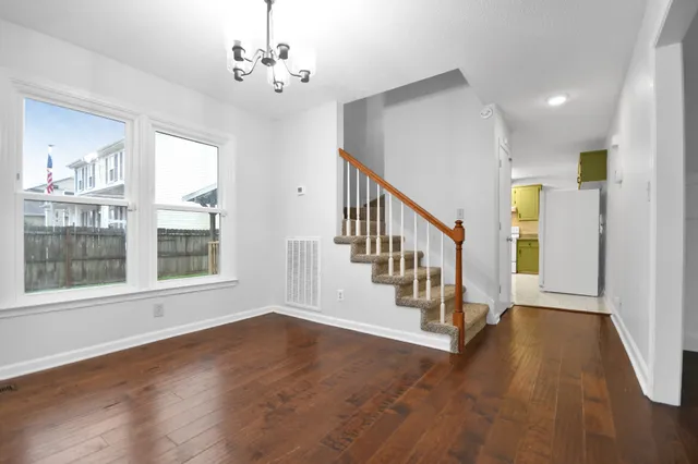 a view of an entryway with wooden floor and windows