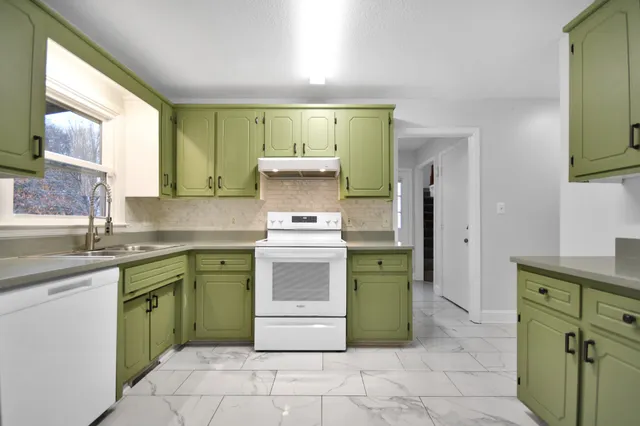a kitchen with a stove top oven sink and cabinets