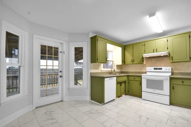 a kitchen with a sink and cabinets