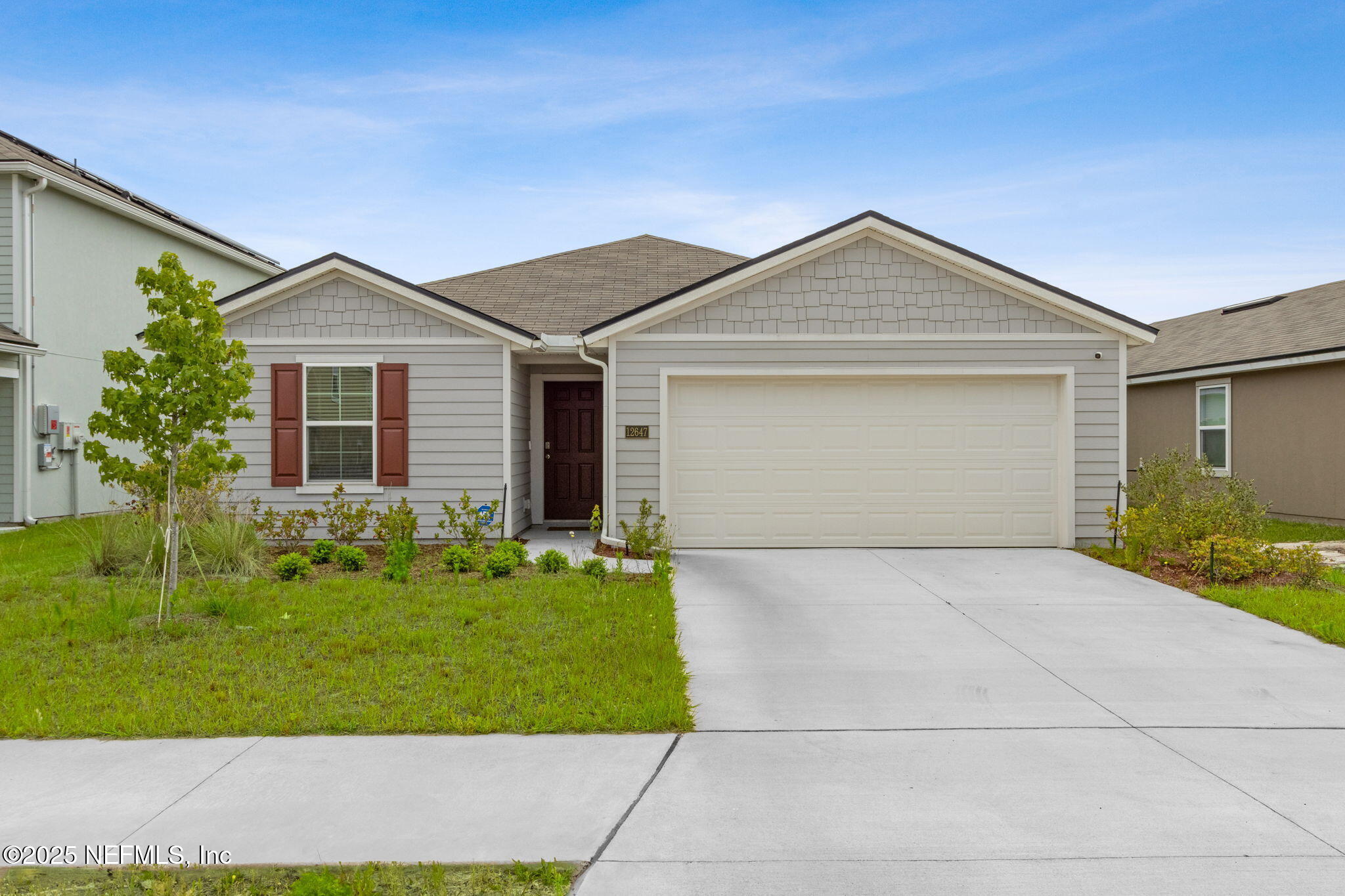 a front view of a house with a yard and garage