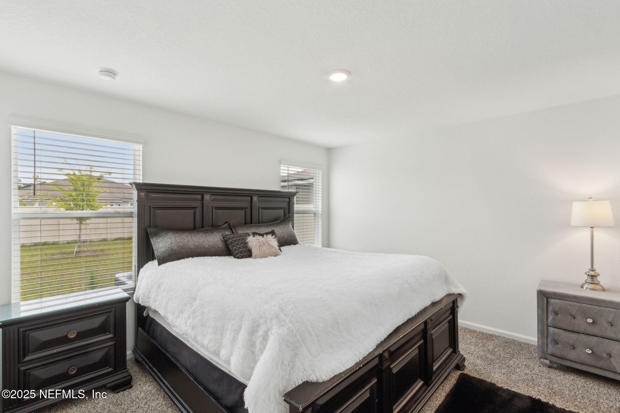 12647 European Beech Road Jacksonville, FL 32218 - Photo 15 of 28 a bedroom with a bed and large window