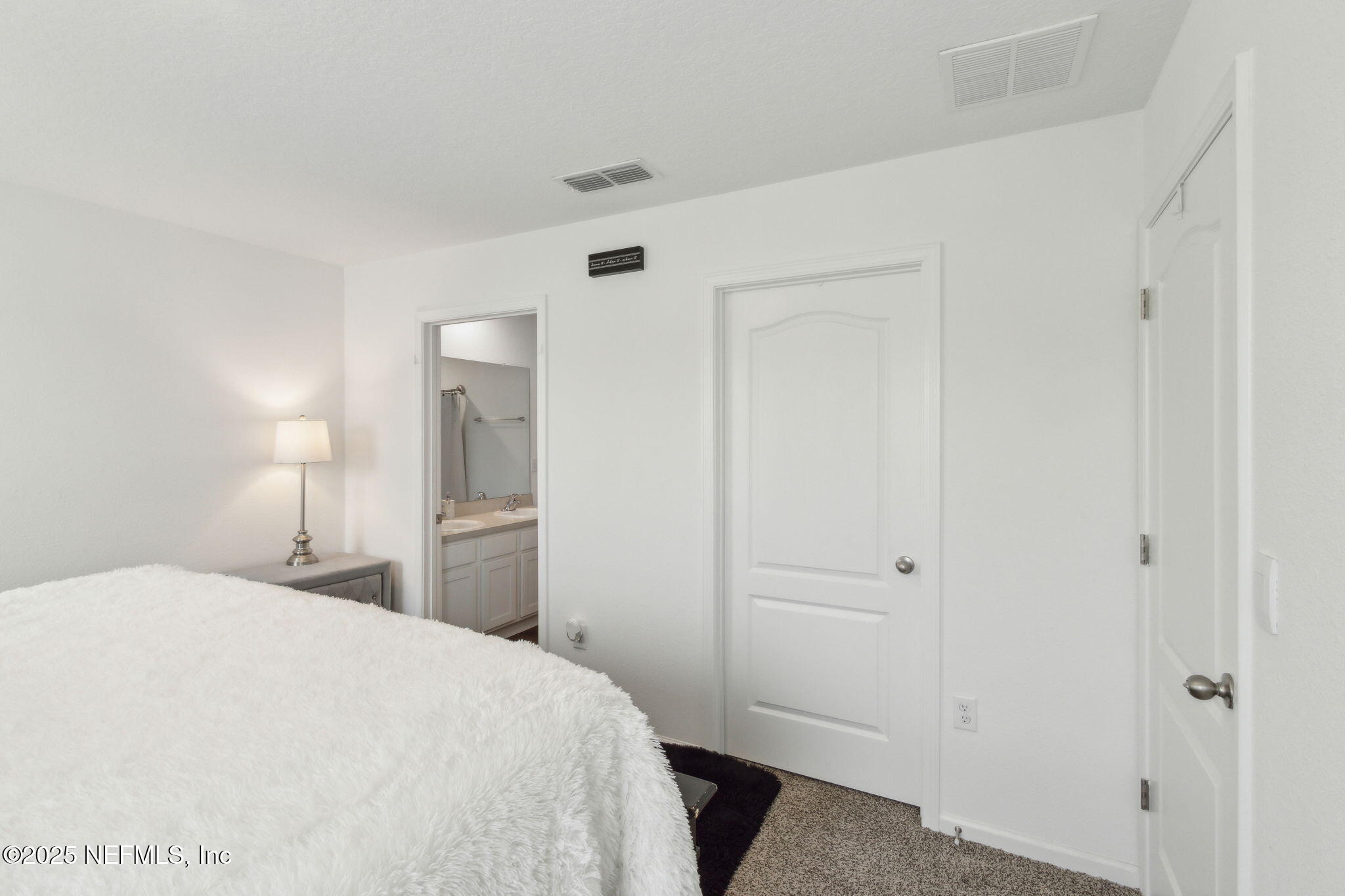 12647 European Beech Road Jacksonville, FL 32218 - Photo 17 of 28 a bedroom with a bed and cabinets