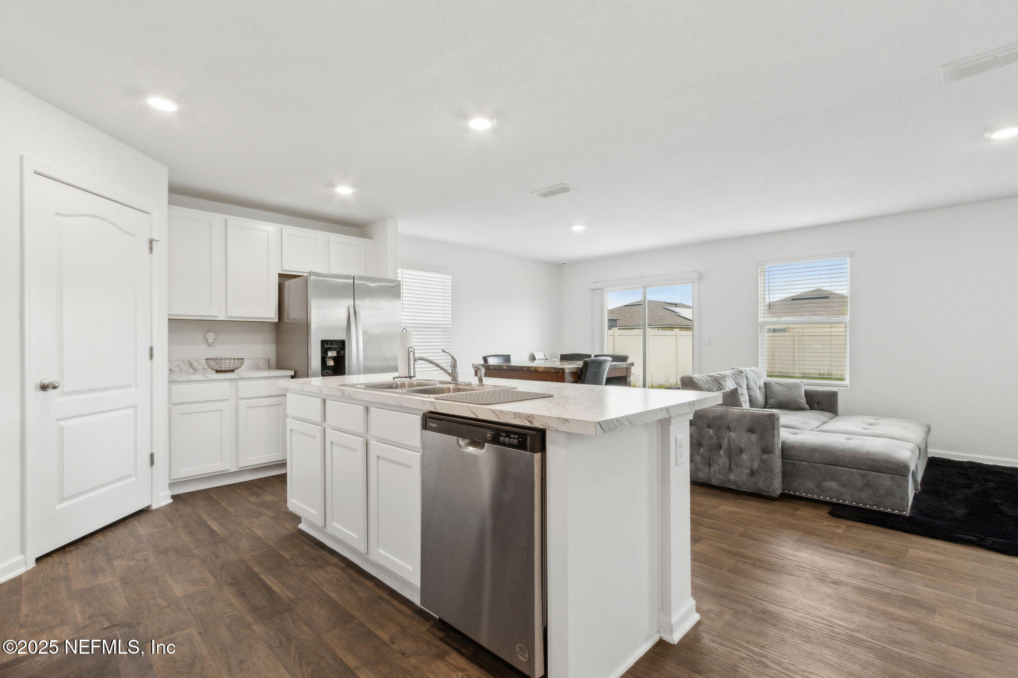 12647 European Beech Road Jacksonville, FL 32218 - Photo 8 of 28 a kitchen with white cabinets and white appliances