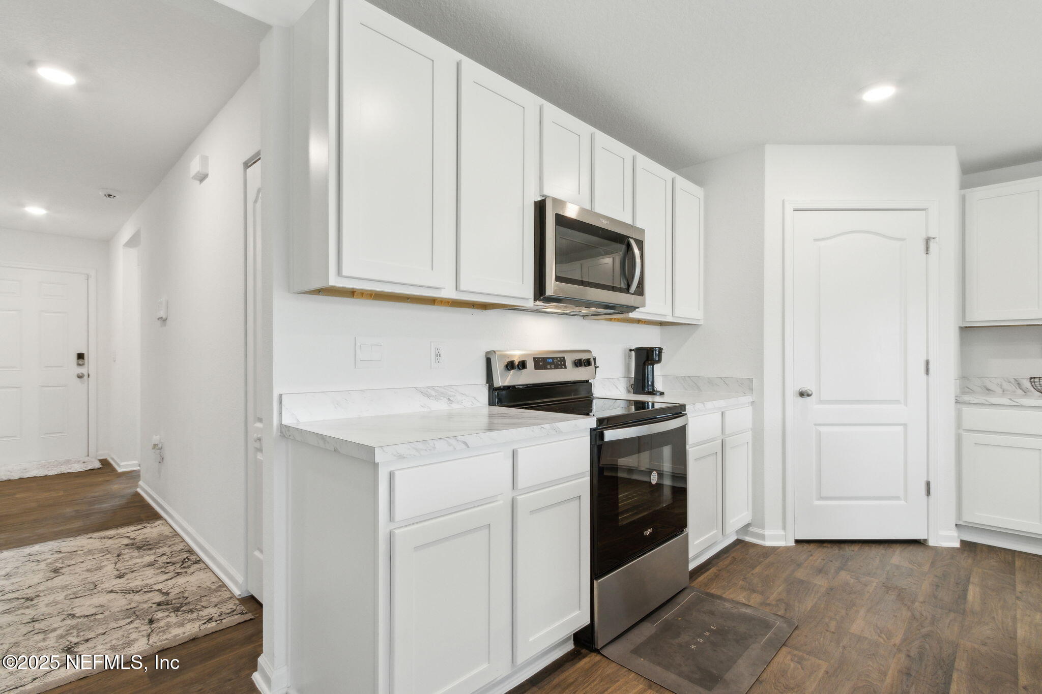 12647 European Beech Road Jacksonville, FL 32218 - Photo 9 of 28 a kitchen with stainless steel appliances granite countertop a stove a sink and a refrigerator