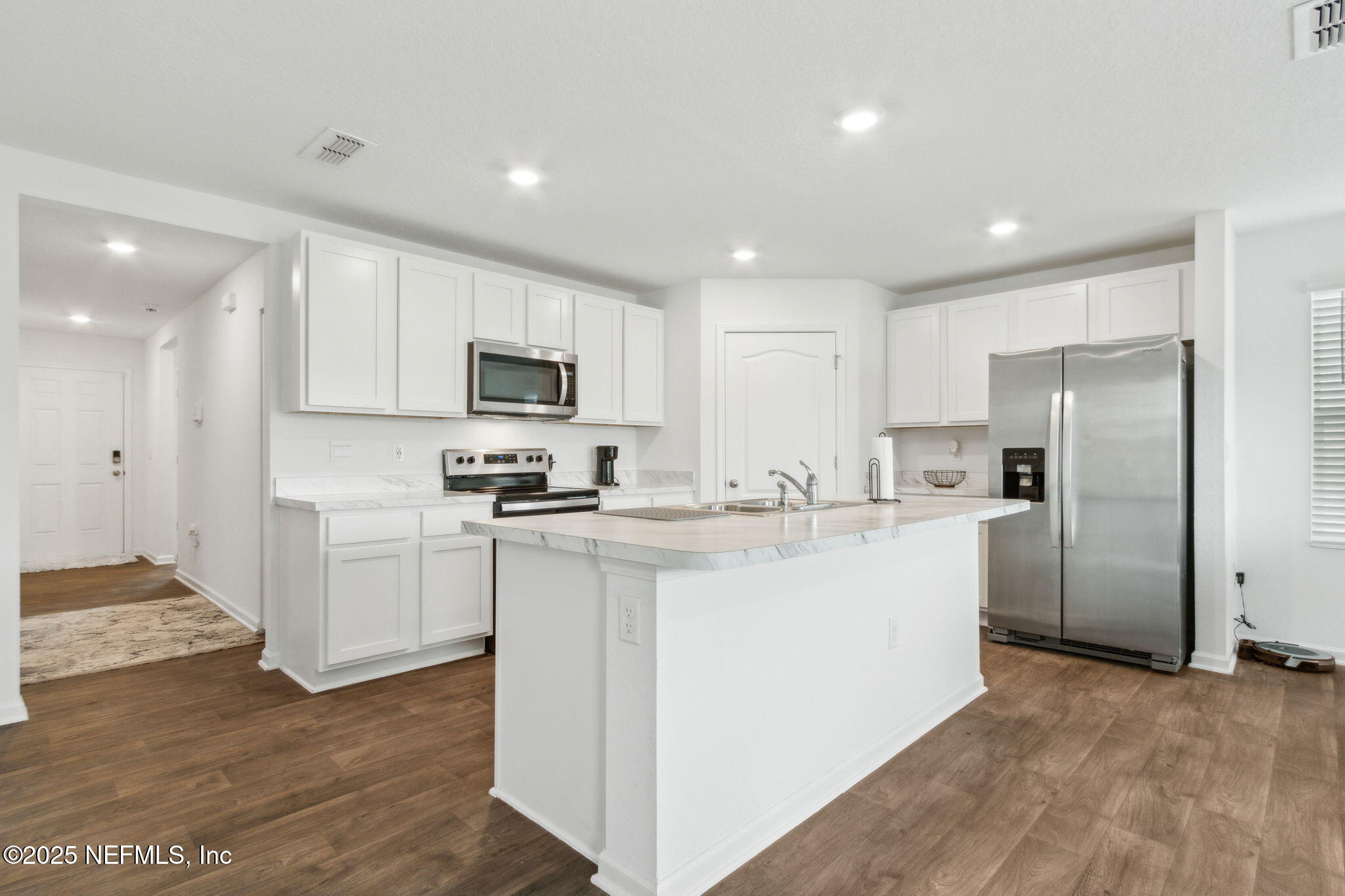 12647 European Beech Road Jacksonville, FL 32218 - Photo 10 of 28 a kitchen with stainless steel appliances granite countertop a refrigerator sink and white cabinets