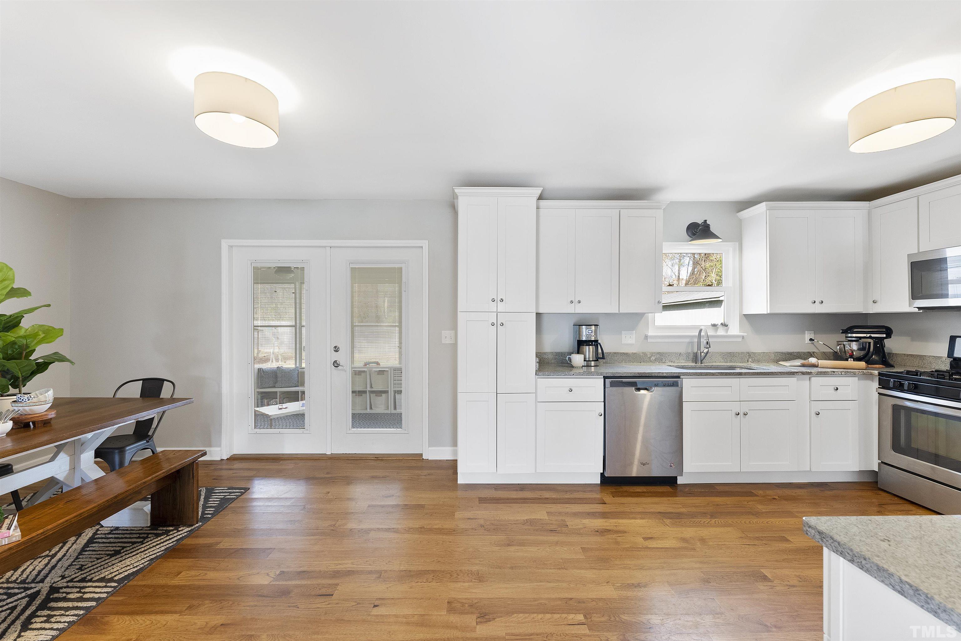 5413 Old Towne Road Raleigh, NC 27612 - Photo 11 of 34 a kitchen with stainless steel appliances granite countertop a stove a sink and a refrigerator