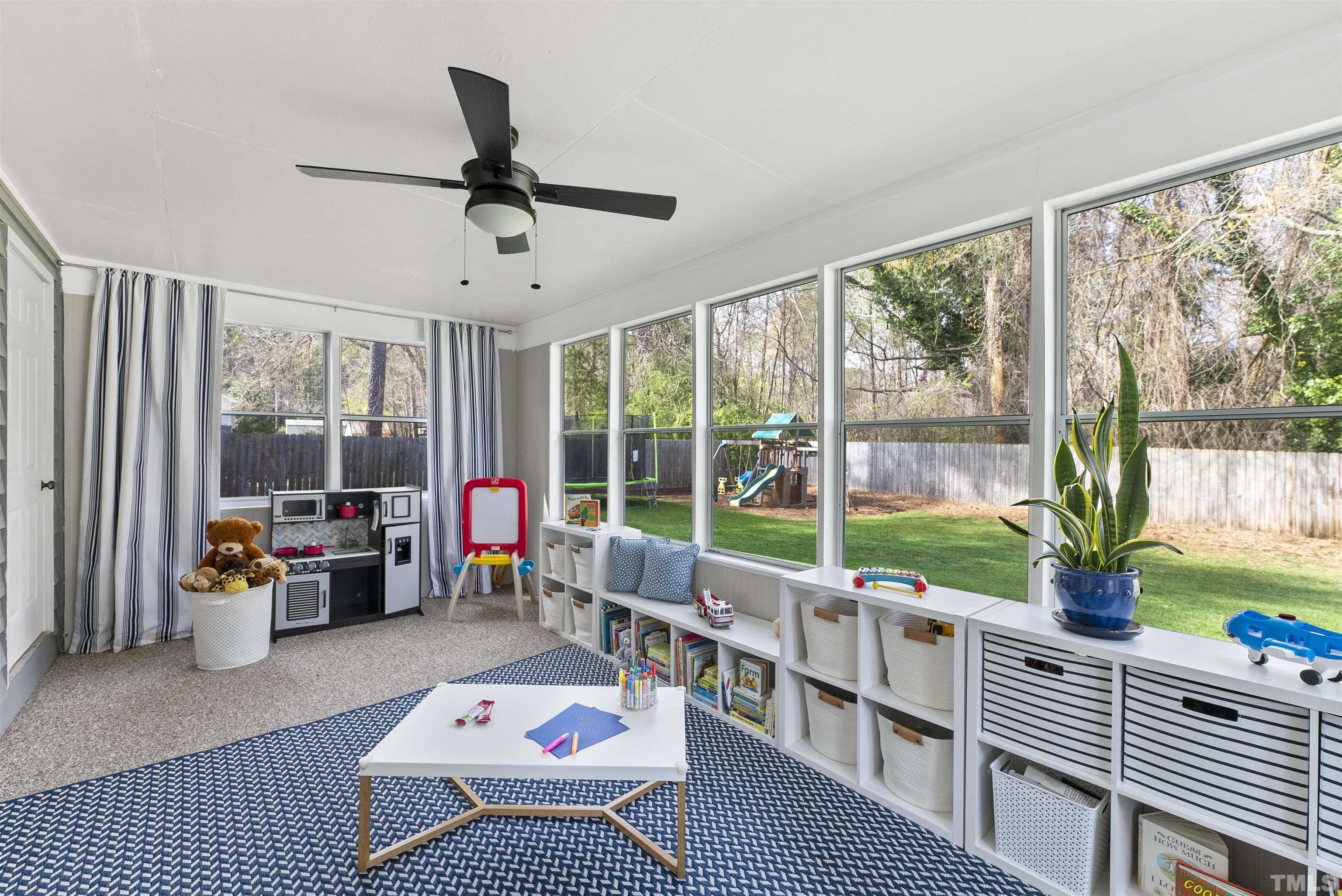 5413 Old Towne Road Raleigh, NC 27612 - Photo 18 of 34 a living room with furniture floor to ceiling window and a table