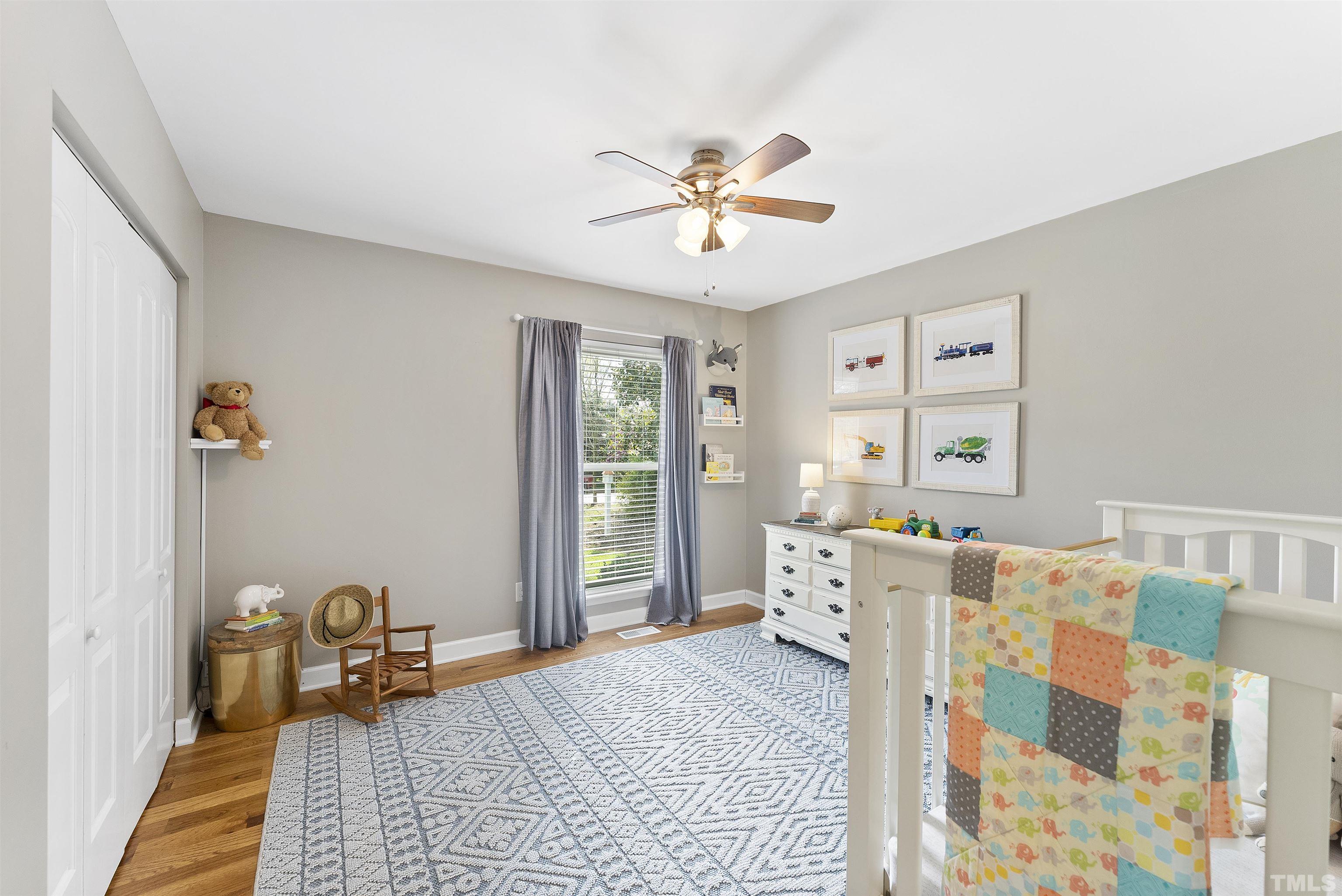 5413 Old Towne Road Raleigh, NC 27612 - Photo 20 of 34 a bedroom with a bed and wooden floor