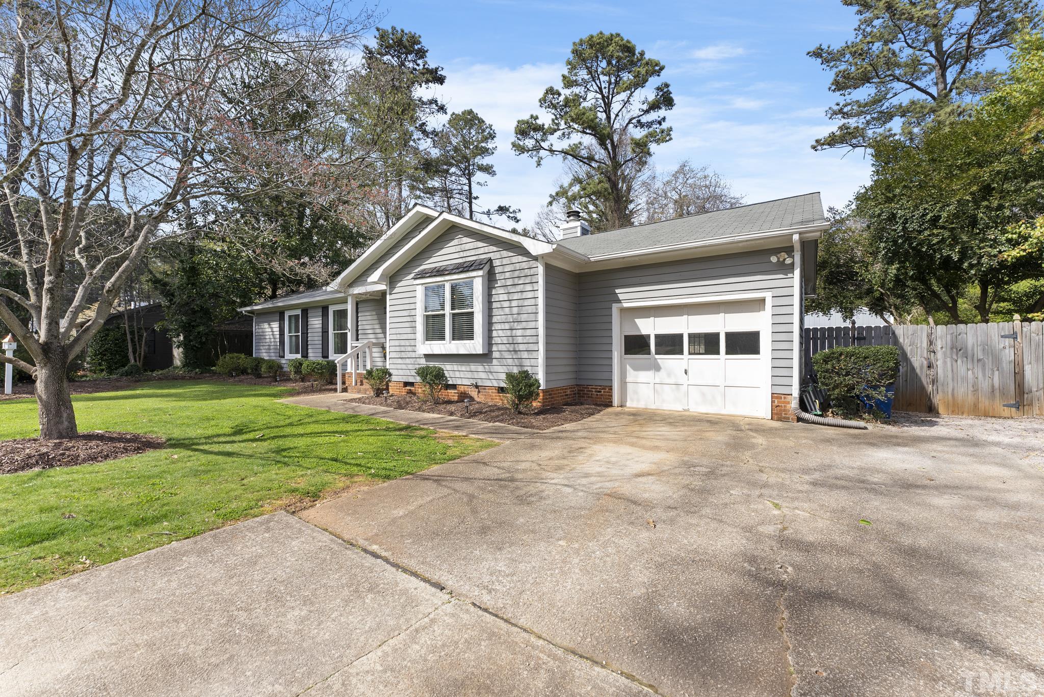 5413 Old Towne Road Raleigh, NC 27612 - Photo 2 of 34 a front view of a house with a yard and trees