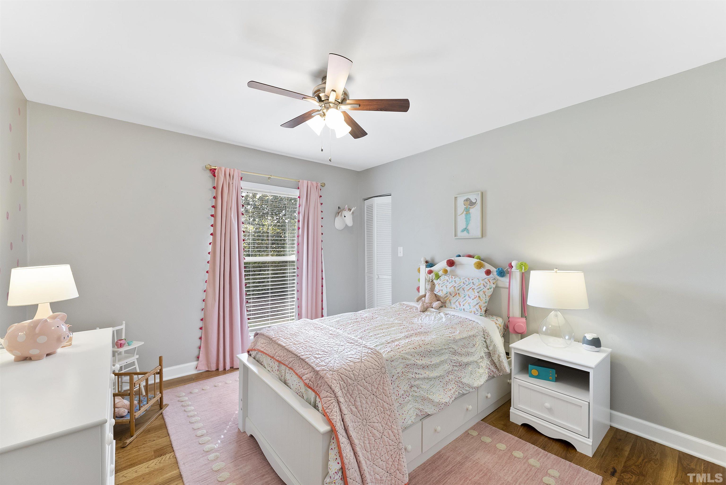 5413 Old Towne Road Raleigh, NC 27612 - Photo 23 of 34 a bedroom with a bed and a chandelier