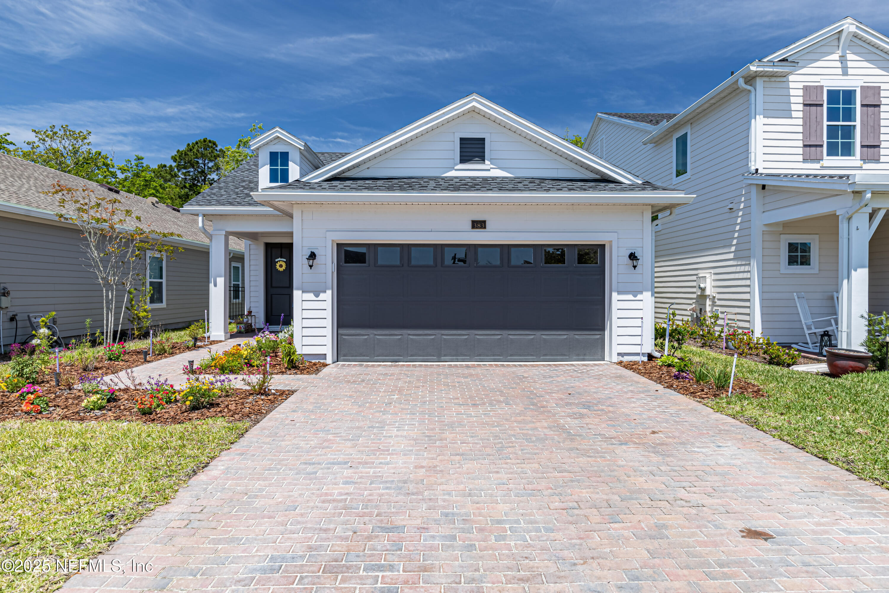 383 Windswept Way Street St. Augustine, FL 32092 - Photo 1 of 34 a front view of a house with a yard and potted plants