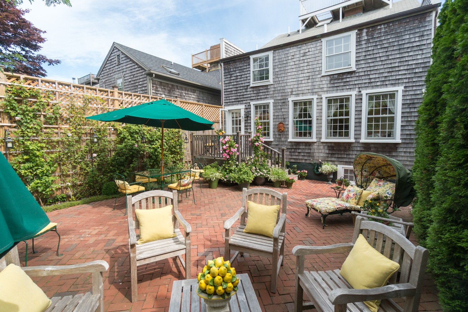 37 Union Street Nantucket, MA 02554 - Photo 5 of 25 a view of a patio with couches table and chairs under an umbrella