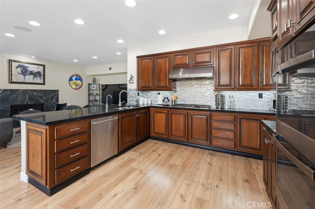 6 Beaconsfield Rancho Santa Margarita, CA 92679 - Photo 11 of 51 Remodeled kitchen with quartz countertops, decorative glass backsplash, new appliances & double ovens