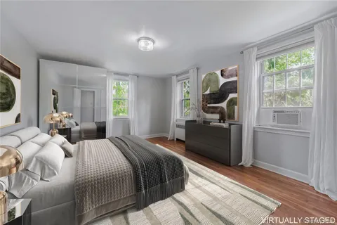 a bedroom with a bed and a large window