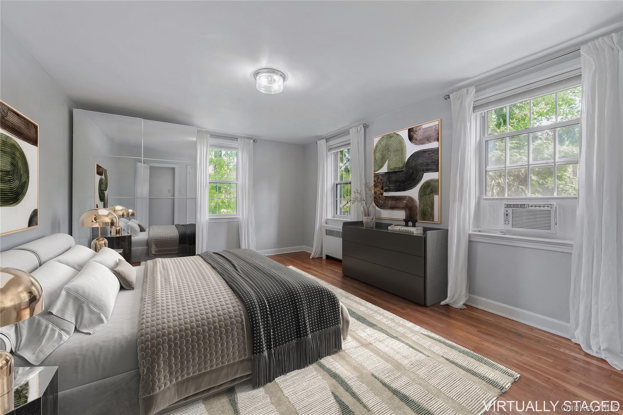 90 Knightsbridge Road, Unit 3N Great Neck, NY 11021 - Photo 10 of 16 a bedroom with a bed and a large window