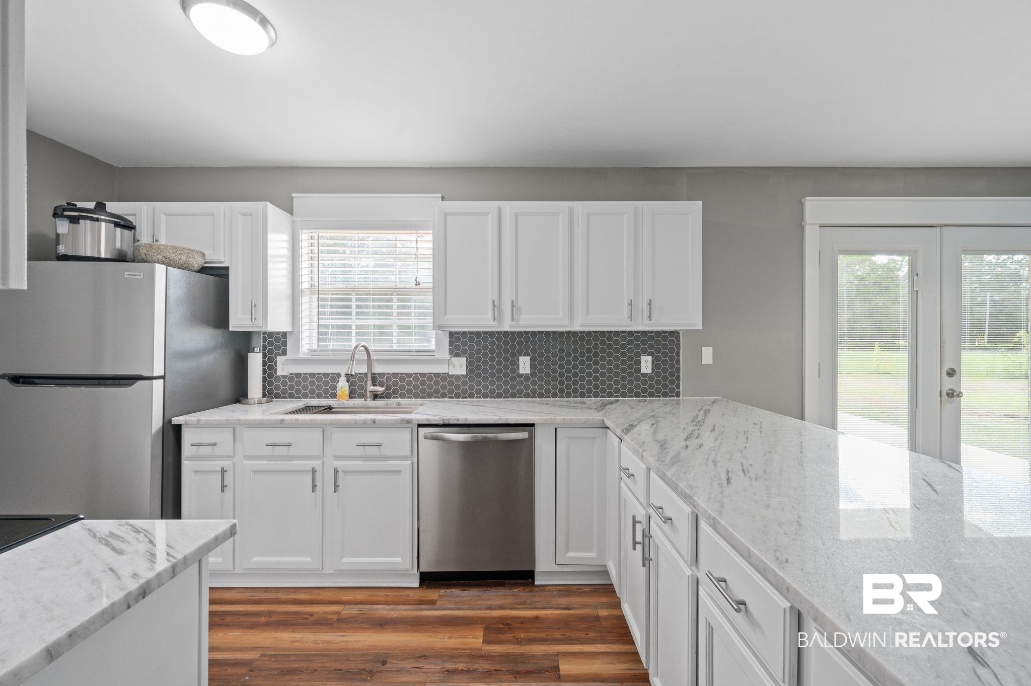 1107 North Oak Street Loxley, AL 36551 - Photo 8 of 40 Kitchen with dark wood-type flooring, plenty of natural light, stainless steel appliances, and sink