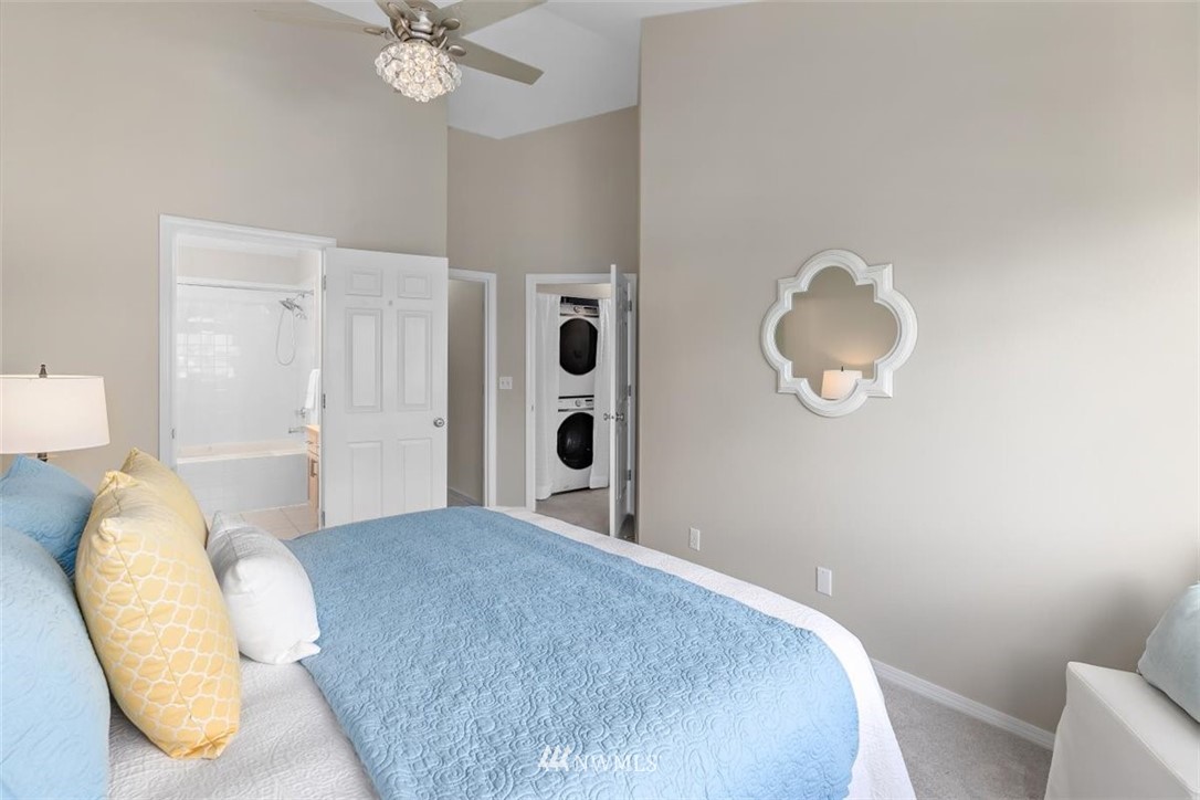 22709 4th Avenue West, Unit 105 Bothell, WA 98021 - Photo 22 of 32 a bedroom with a bed and a chandelier