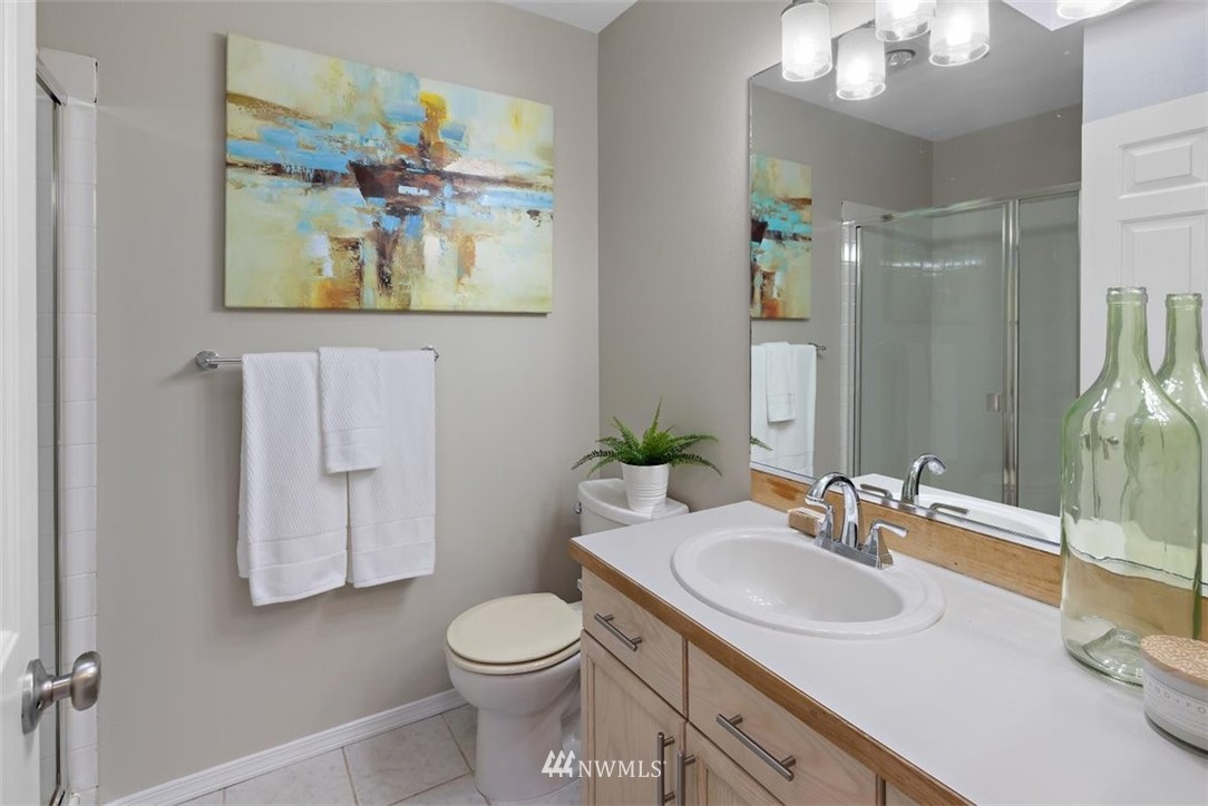 22709 4th Avenue West, Unit 105 Bothell, WA 98021 - Photo 27 of 32 a bathroom with a toilet sink and mirror