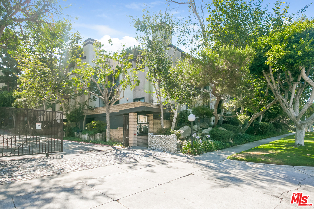 a view of a house with a tree in front of it
