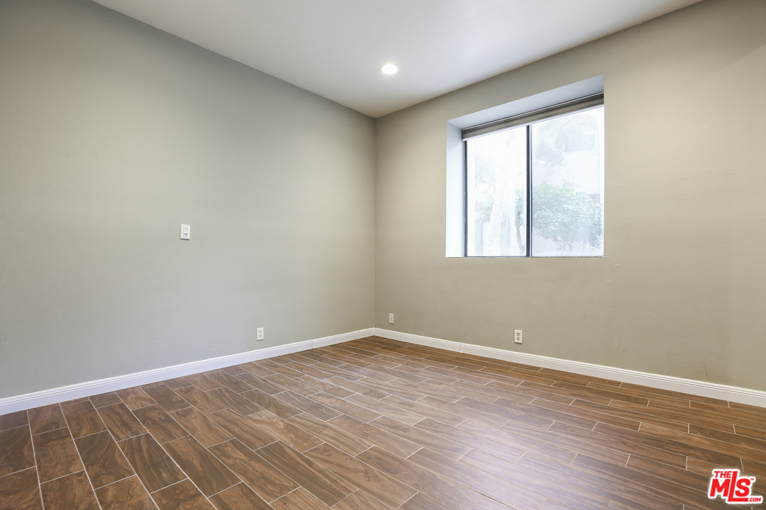 8110 Manitoba Street, Unit 105 Playa del Rey, CA 90293 - Photo 15 of 28 an empty room with wooden floor and windows