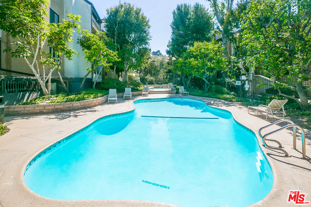 8110 Manitoba Street, Unit 105 Playa del Rey, CA 90293 - Photo 21 of 28 a view of a swimming pool with a yard and sitting area