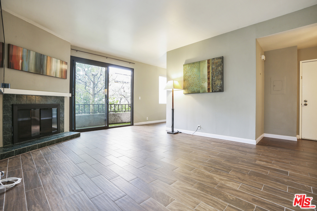 8110 Manitoba Street, Unit 105 Playa del Rey, CA 90293 - Photo 8 of 28 a view of an empty room with glass door and wooden floor