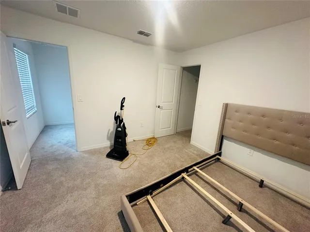 a view of a livingroom with wooden floor and stairs