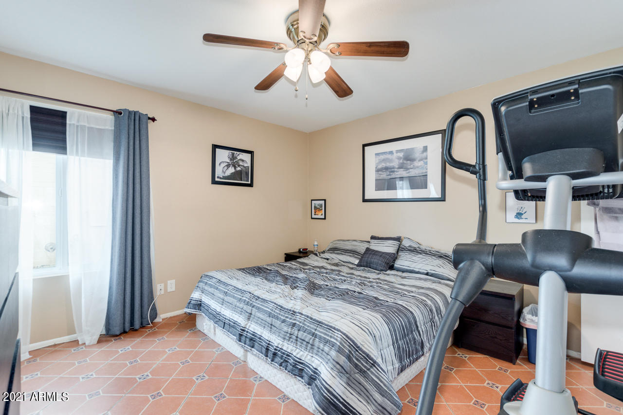 4215 West Dailey Street Phoenix, AZ 85053 - Photo 18 of 32 a bedroom with a bed and a flat screen tv